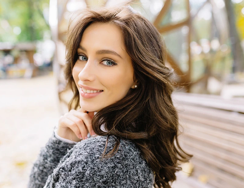 Portrait of beautiful brunette woman looking back at camera