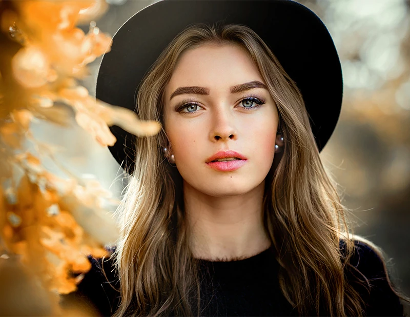 Portrait of beautiful young woman wearing hat