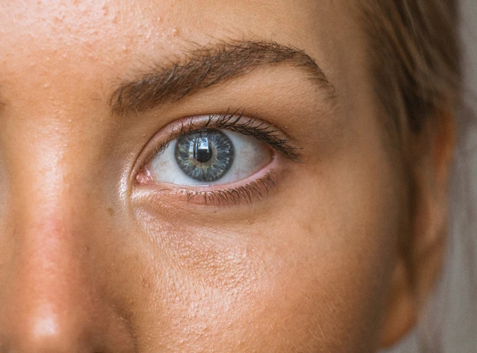 close up of womans blue eye